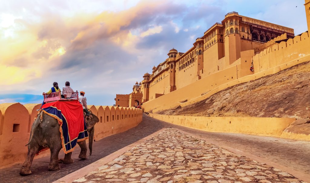 Amer Fort Jaipur Tourists enjoy elephant ride at sunrise